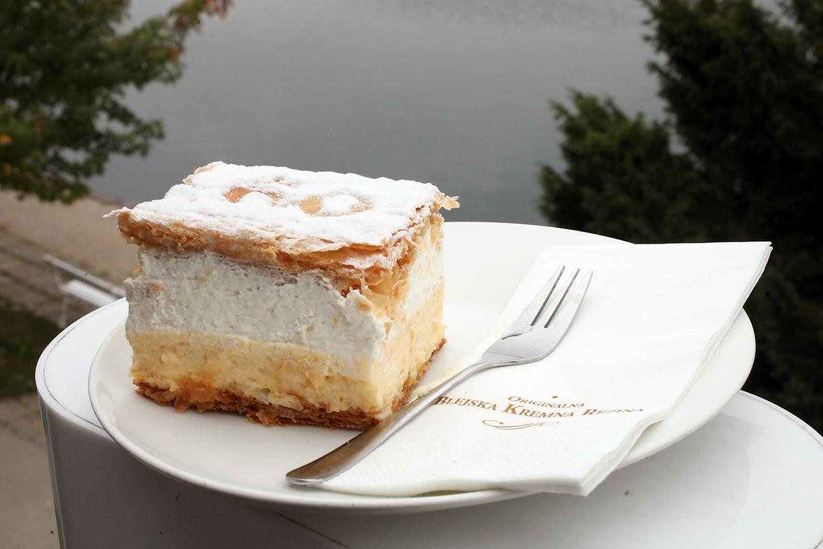 The cream cake may look deceptively simple at first glance: a small cube of custard and whipped cream with pieces puff pastry on the top and the bottom. However, the combination has proved so popular that “kremšnita” now ranks as one of Slovenia’s most famous dishes. Foto: Sava Turizem