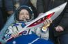 Foto: Olimpijska bakla se je po vesoljskem sprehodu vrnila na Zemljo