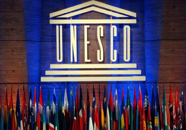 Znak organizacije UNESCO in spodaj zastave. Foto: AP