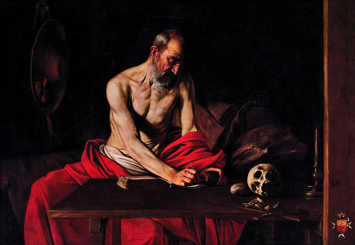 Hieronim, kot ga je leta 1607 v svoji naturalistični maniri naslikal Caravaggio. Odet v kardinalsko rdečo barvo in s svojim stalnim atributom, lobanjo, ob strani je zatopljen v delo. Njegovo telo priča o asketskem življenju učenjaka, zagorel obraz pa o njegovem umiku v puščavo. Foto: Wikipedia