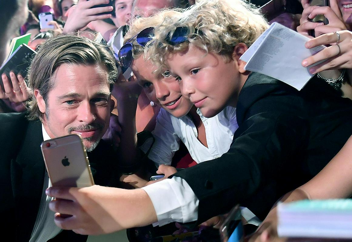 Brad Pitt na beneški premieri Ad Astre uslužno pozira za selfije ob rdeči preprogi. Foto: EPA