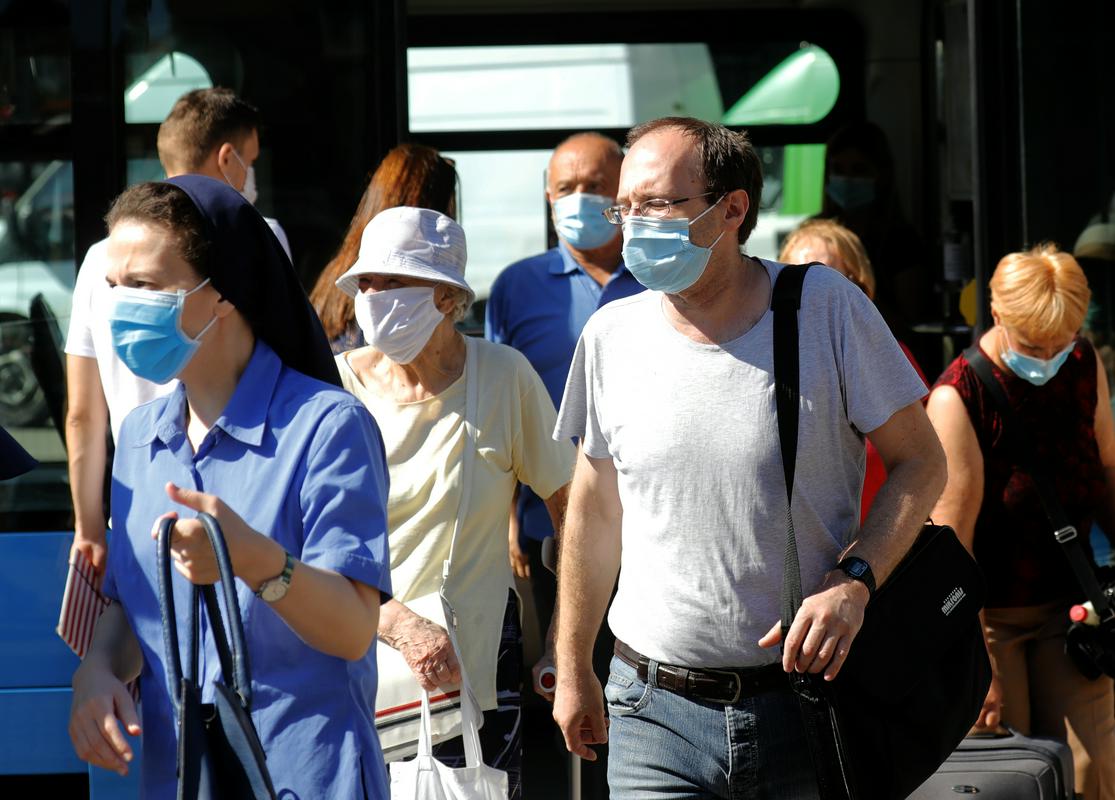 Ljudje v Zagrebu nosijo maske, ki so obvezne v vseh zaprtih prostorih. Foto: EPA