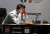 Carlsen naredil napako v 10. potezi, a se je rešil v delitev točk