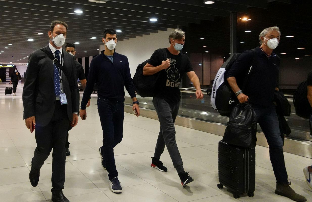 Novak Đoković v spremstvu svoje ekipe na letališču v Melbournu. Foto: Reuters