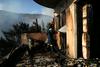 Gozdni požar v predmestju Aten pod nadzorom, poškodovanih več hiš
