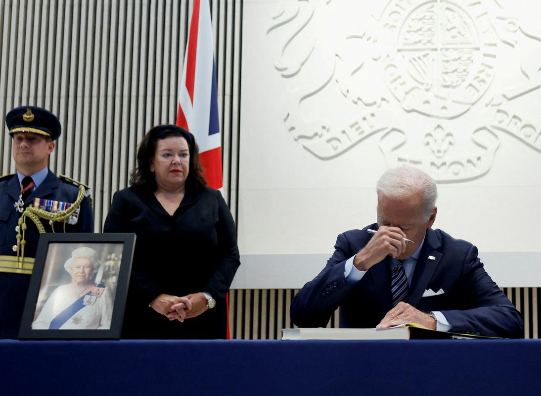Ameriškega predsednika Bidna so ob podpisu v žalno knjigo prevzela čustva. Foto: Reuters