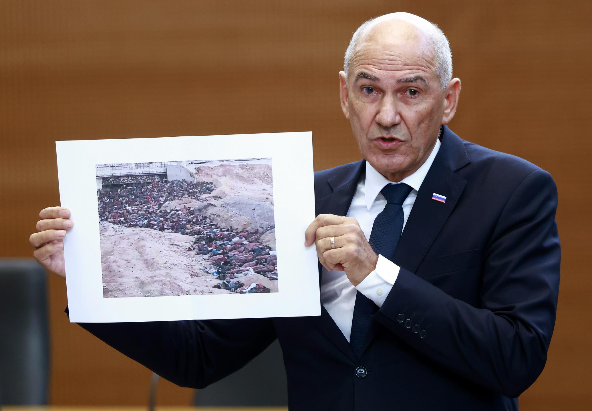Janša v DZ-ju pokazal fotografijo iz Gaze in trdil, da gre za trupla kristjanov v Sudanu